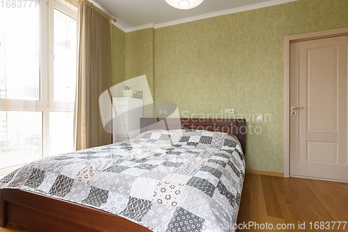 Image of The interior of the bedroom with a large double bed, next to the interior door