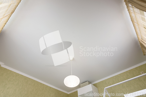 Image of Stretch white matte ceiling close-up in the interior of a bedroom