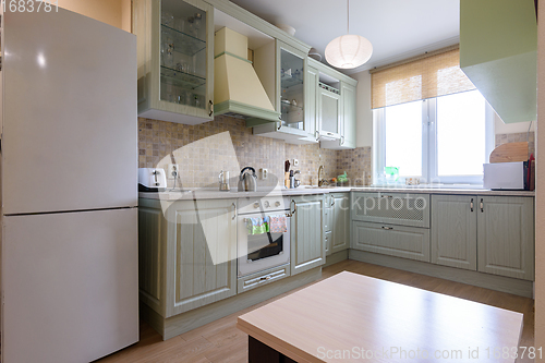 Image of Interior of a modern classic kitchen with a corner kitchen set by the window