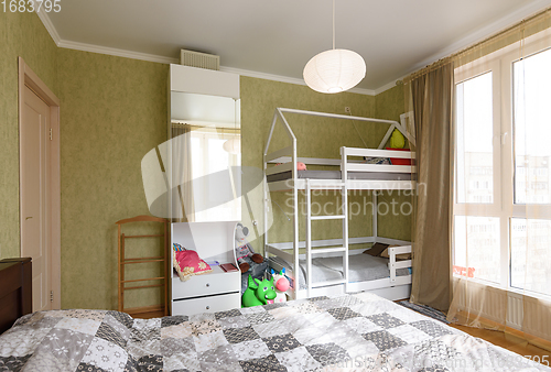 Image of Interior of an adult bedroom, in the room there is a children\'s bunk bed