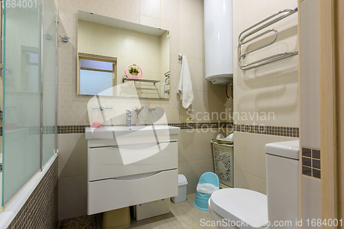 Image of Interior of a modern bathroom combined with a toilet