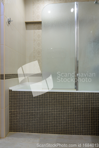 Image of The bathroom is separated from the bathroom by a glass partition, the partition door is closed