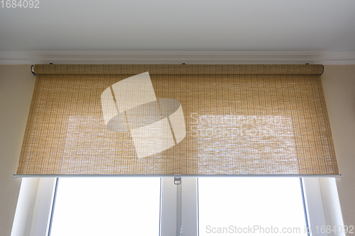 Image of Roller blinds made of thin bamboo on the window