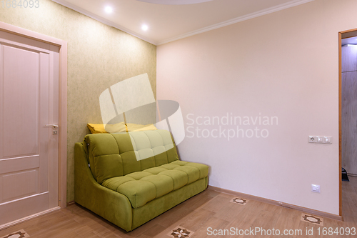 Image of Fragment of the living room interior in a small apartment, the sofa stands against the wall