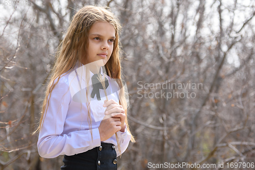 Image of Portrait of a girl with dried wildflowers in her hands on a forest background