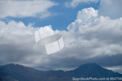 Image of volcanic mountains and sky with clouds