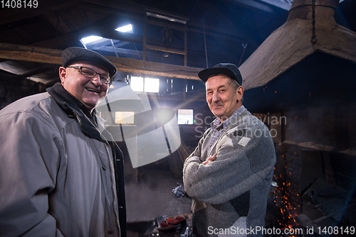 Image of portrait of two confident senior blacksmith