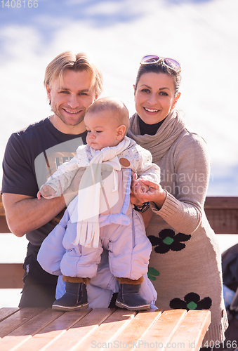 Image of young happy family with little child enjoying winter day