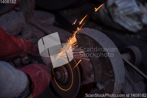 Image of the blacksmith polishing metal products