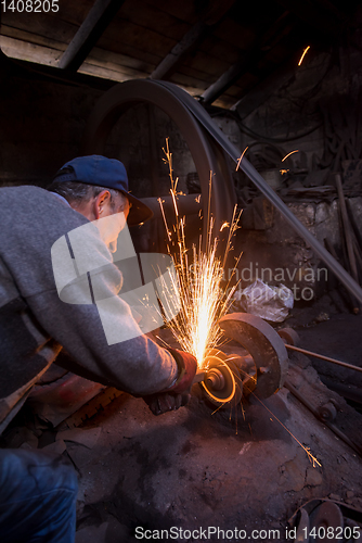 Image of the blacksmith polishing metal products