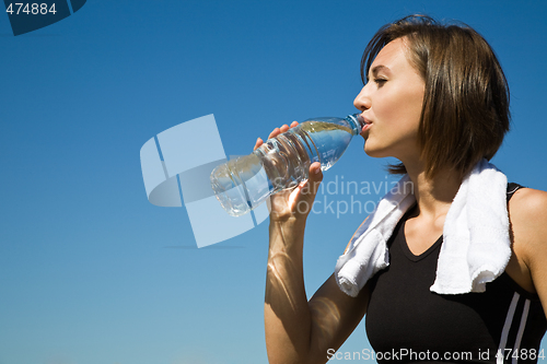 Image of Caucasian girl drinking water after exercise