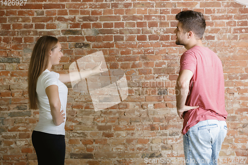 Image of Young couple doing apartment repair together themselves