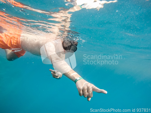 Image of Young boy Snorkel swim in coral reef