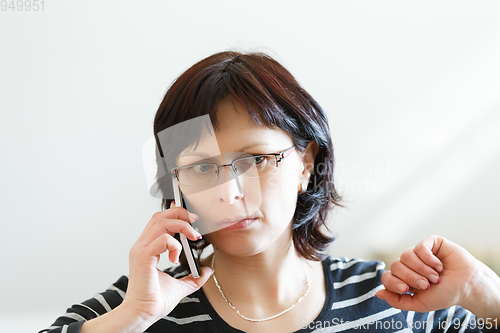 Image of tired middle-aged woman call by phone