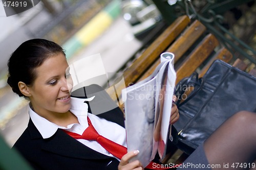 Image of businesswoman reading magazine