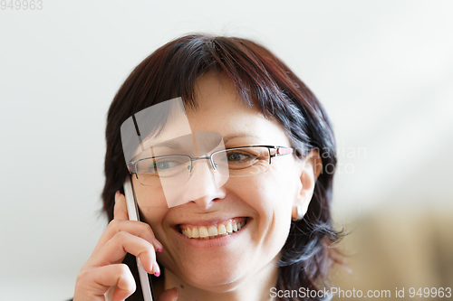 Image of smiling middle-aged woman call by phone