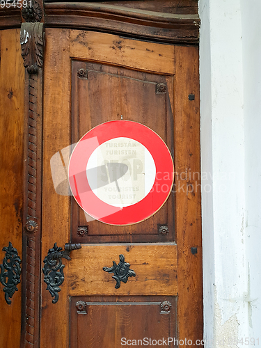 Image of Sign stop Tourist on door to church.