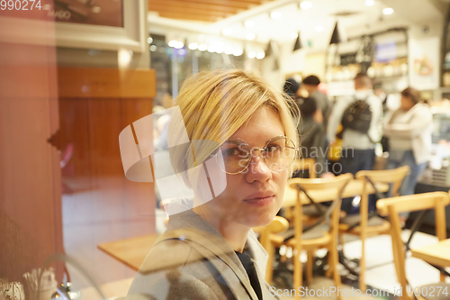 Image of Closeup portrait of an elegant middle aged woman wearing glasses