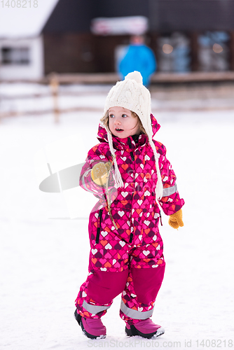 Image of little girl having fun at snowy winter day