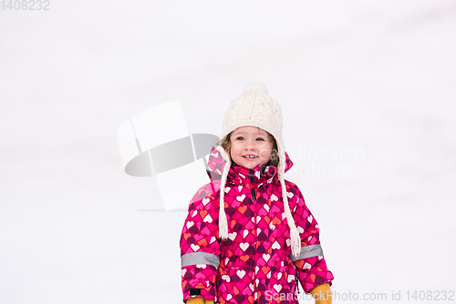 Image of little girl having fun at snowy winter day