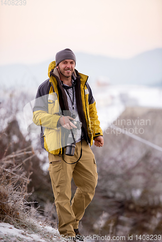 Image of portrait of male photographer at winter nature