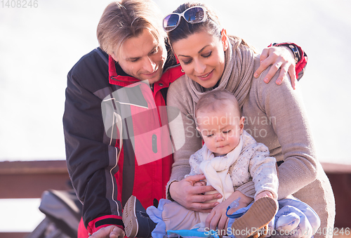 Image of young happy family with little child enjoying winter day