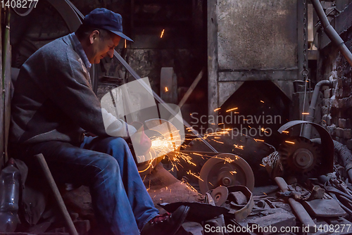 Image of the blacksmith polishing metal products