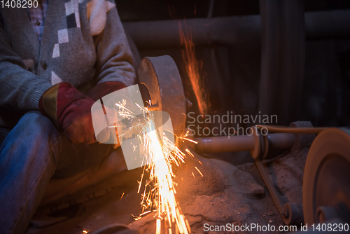 Image of the blacksmith polishing metal products