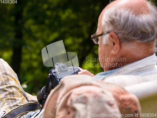 Image of senior photographer preparing camera