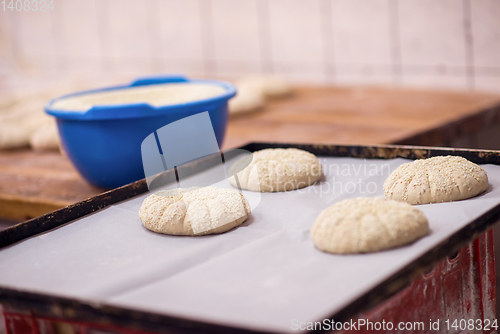 Image of balls of dough bread getting ready to be baked