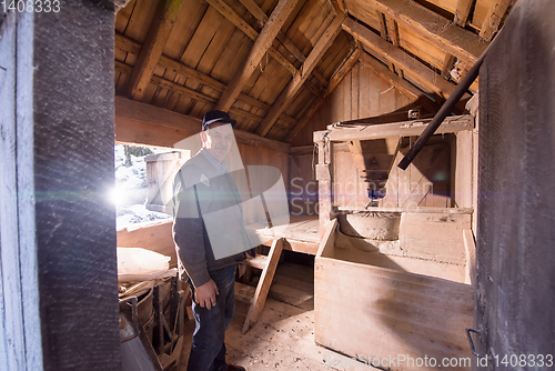 Image of portrait of a miller in retro wooden watermill