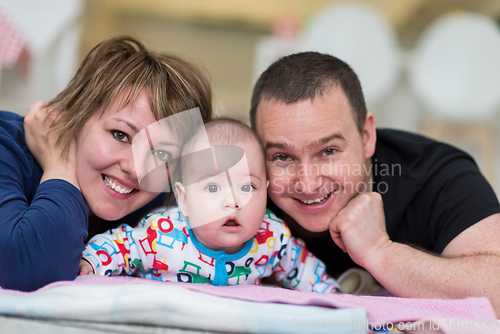 Image of Portrait of young happy couple with their adorable baby boy