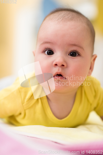 Image of newborn baby boy playing on the floor