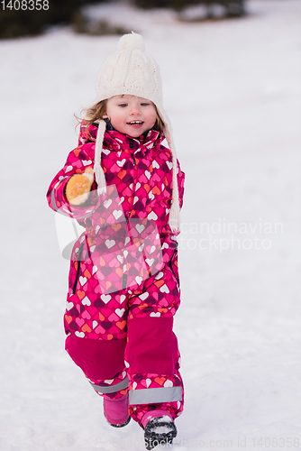 Image of little girl having fun at snowy winter day