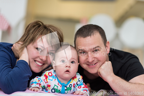 Image of Portrait of young happy couple with their adorable baby boy