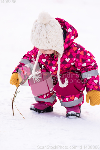 Image of little girl having fun at snowy winter day