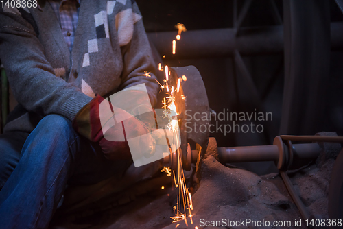 Image of the blacksmith polishing metal products