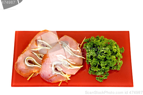 Image of Tenderloin with ham and cheese on red plate