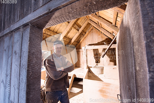 Image of portrait of a miller in retro wooden watermill