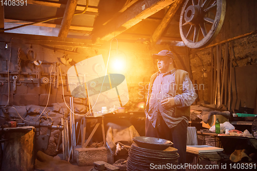 Image of portrait of confident senior blacksmith