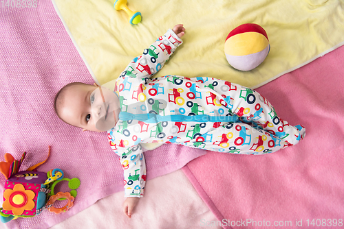 Image of top view of newborn baby boy lying on colorful blankets