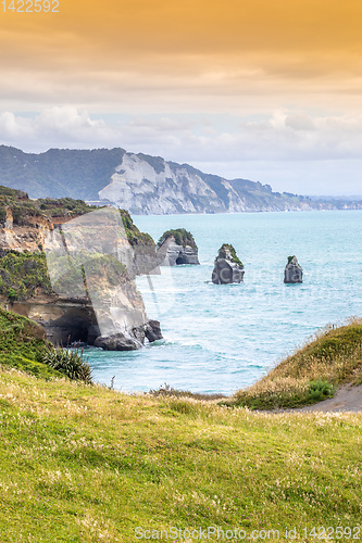 Image of sea shore rocks and mount Taranaki, New Zealand