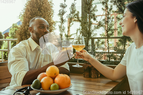 Image of Young friends or couple drinking beer and celebrating together