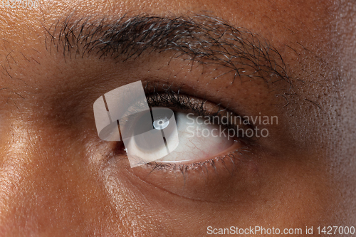Image of Close up portrait of young man on blue background.