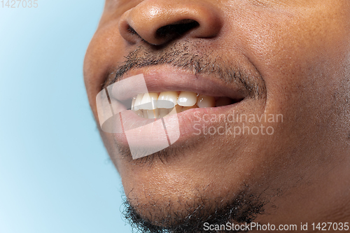 Image of Close up portrait of young man on blue background.