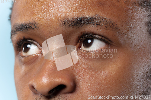 Image of Close up portrait of young man on blue background.