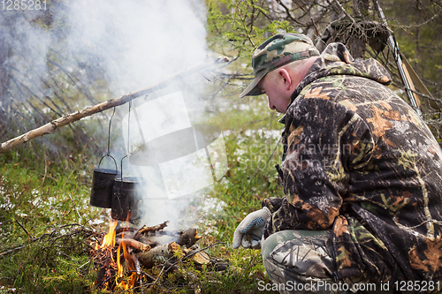 Image of Huntsman has been cooking over a campfire