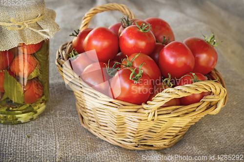 Image of Still life of a basket of tomatoes on canvas