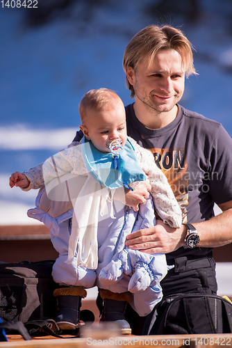 Image of young happy family with little child enjoying winter day