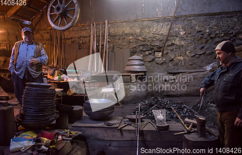 Image of portrait of two generations traditional blacksmith